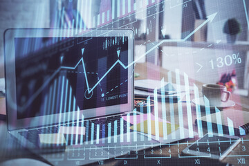 Financial chart drawing and table with computer on background. Double exposure. Concept of international markets.