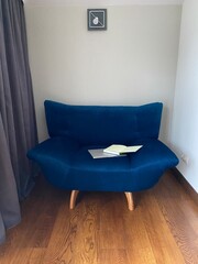 Blue sofa in a room with white walls