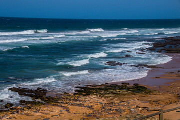 Rocks on Shoreline Protruding from Water at Low Tide