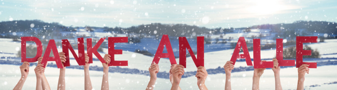 People Hands Holding Colorful German Word Danke An Alle Means Thank You All. Snowy Winter Background With Snowflakes