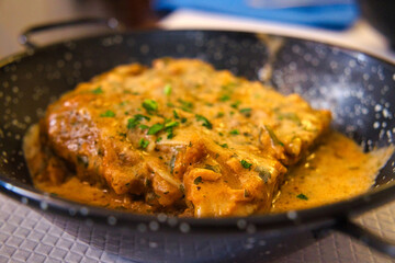 A piece of delicious Italian lasagna in rich fish sauce