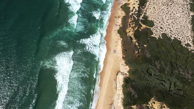 Aerial View coast line jib up. Waves Break On White Sand Beach 