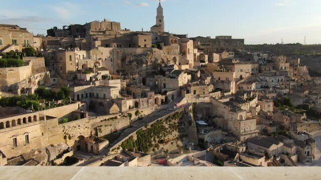 sassi di matera aerial view at sunrise drone flying moving out from the house balcony
