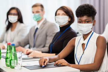 business and pandemic concept - group of people wearing face protective medical mask for protection...