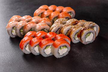 Fresh delicious beautiful sushi rolls on a dark background
