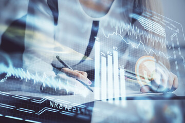 Technology theme hologram over woman's hands taking notes background. Concept of Tech. Double exposure