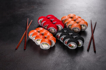 Fresh delicious beautiful sushi rolls on a dark background