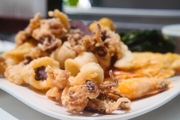Delicious Slovenian food - breaded seafood (baby octopus, shrimps sardina, mussels and calamary rings in tempura) from fresh catch of the day from Adriatic sea