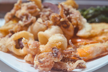 Delicious Slovenian food - breaded seafood (baby octopus, shrimps sardina, mussels and calamary rings in tempura) from fresh catch of the day from Adriatic sea