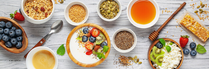 Healthy breakfast set with yogurt, berries, coffee and granola. Top view. Flat lay