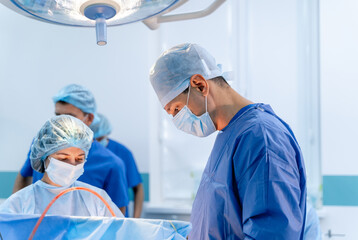 Neurosurgeons working in operating room. Hospital background. Doctors at work. Operaton on brain.