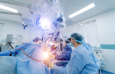 Robotic equipment in modern neurosurgery clinic. Team of neurosurgeons providing operation. Selective focus. Closeup.