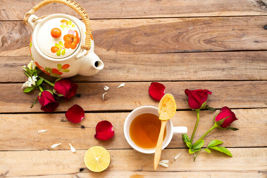 herbal healthy drinks lemont tea health care for cough sore with  teapot of lifestyle relax with red rose flowers  arrangement flat lay style on background wooden 