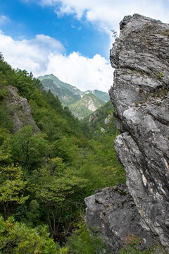 Vertical image of steep rock looking out in the canyon of a mountain range in pozar, north Greece
