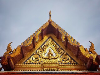 The shiny and beautiful pediment in grand palace Bangkok , Thailand