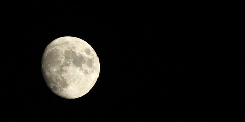 a half moon shining in black night