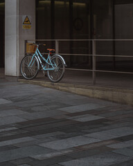 A lone bicycle leans against railings in Manchester City Centre