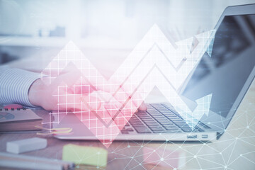 Growing arrows with businessman working on computer on background. Success concept. Double exposure.