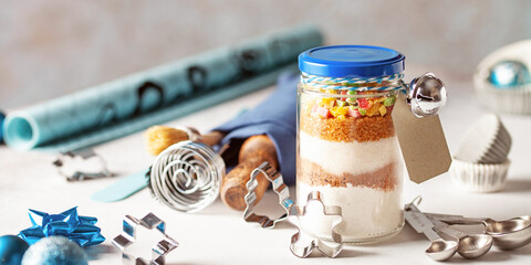 Ingredients for Christmas cookies in a jar on a festive background. Eco friendly concept