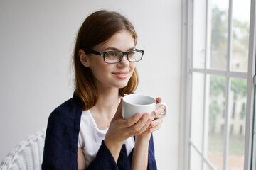 Cheerful woman cup of coffee morning home interior 