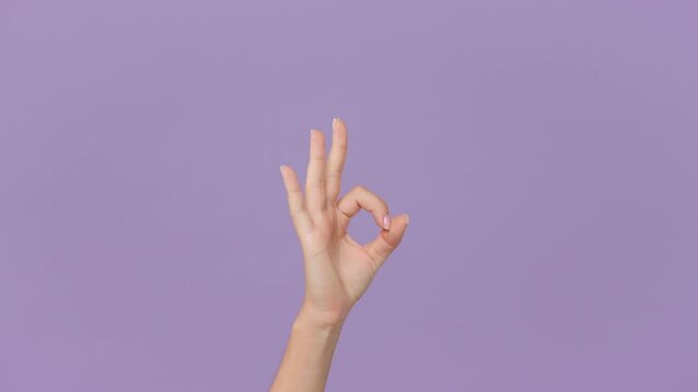 Close up cropped woman hand showing OK sign okay gesture isolated on pastel purple violet background in studio. Copy space place for text image promotional content. Advertising area workspace mock up