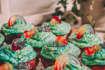 rainbow cupcakes with sprinkles and unicorn gummies