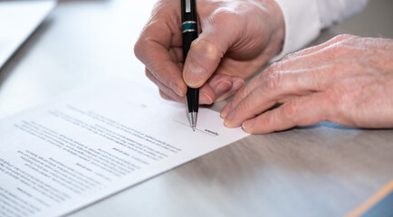 Hand of businessman signing a document