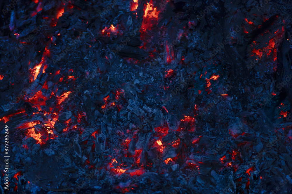 Wall mural background of red burning coals in the night