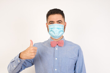 Good job! Portrait of a happy smiling blue eyed young successful man giving thumb up gesture standing outdoors. Positive human emotion facial expression body language. Funny girl