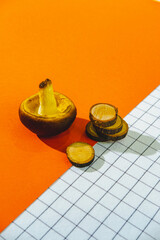 Mushroom and wooden cuts on bright orange and white solid background. Autumn fall season concept.