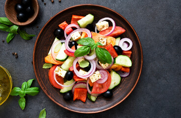 Classic Greek salad with feta on a wooden background.