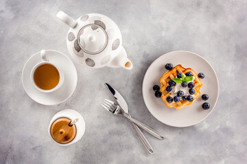 Breakfast Homemade belgian waffles on served table on gray marble background top view