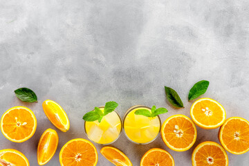 Chilled Orange Juice with Ice on gray stone background top view flat lay copy space