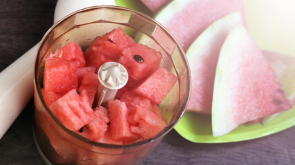 Ripe watermelon slices in a blender