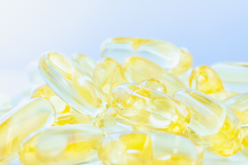 Big pile of omega 3 gel pills on a white table