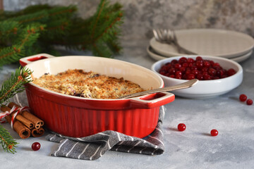 Crumble with berries and nuts on a concrete background.