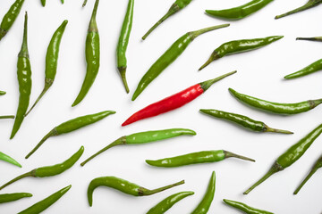 Red and green chilli peppers on a white background.
