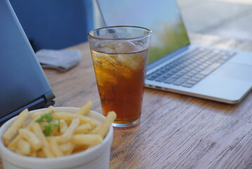 A glass of iced tea on top of a cafe desk