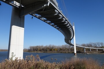 The Bob Kerrey Pedestrian Bridge crosses over the river, connecting Omaha, Nebraska with Council Bluffs, Iowa
