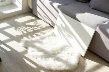 Blank white poster banner standing in the apartment. Mock up template for present business concept.