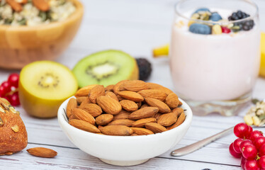 Group Fruits Breakfast with bread Whole grains and nuts, yogurt mix with Cherry , banana, avocado in the wooden table. Breakfast for Health and Diet concept