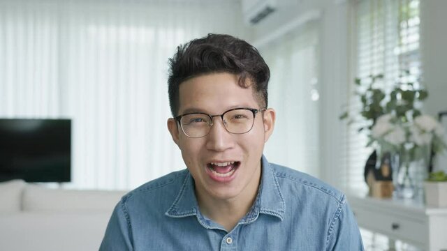 POV screen camera shot ,confident asian creative man vlogger make live video conference call, chat online on computer and sitting on table at home, Webcam view, video chat and Self isolation concept.