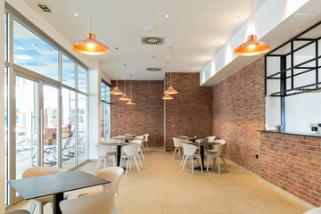 Interior of a empty hotel restaurant with brick wall