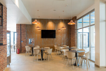 Interior of a empty hotel restaurant with brick wall