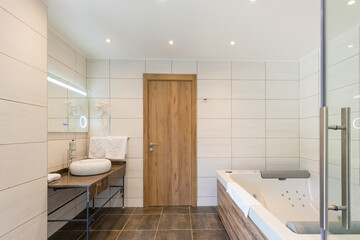 Interior of a hotel bathroom with hydromassage bath tub