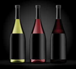 Set of three bottles of wine on a dark background.