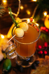 citrus tea in transparent mug with apple, feijoa  and lychee on the table in restaurant