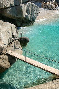 Vertical of wooden bridge in Ikaria over blue water