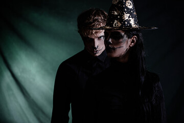 Halloween couple. Halloween concept. Man and woman posing. Hat. Costume. Celebration. 