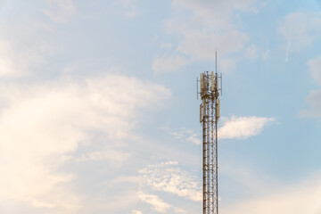 Telecommunication tower with blue sky and cloud in background. Broadcast pole with copy space. Wireless communication technology.